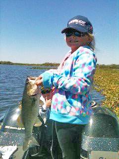 A lady showing her prize fish