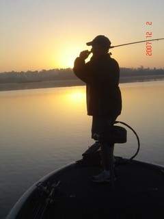 Man fishing at sunset