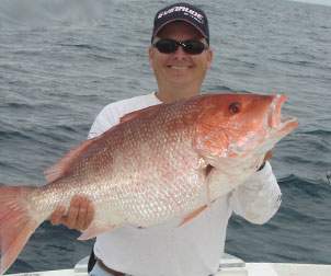 Man holding up a large Red Snapper with both hands